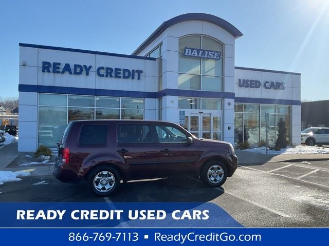 2015 Honda Pilot LX in Red — front three-quarter view